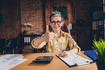 Photo of attractive successful nice woman economist bookkeeper thumb up agreement indoors...