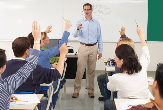 Students Raising Hands in Classroom