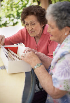 Women Looking in Box of Letters