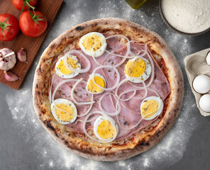 Portuguese pizza over stone background with ingredients