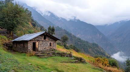 A small hut nestled in the mountains, surrounded by rugged terrain and natural beauty.