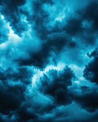 Dramatic, stormy blue clouds create a captivating and moody atmosphere, perfect for use in backgrounds or weather-related themes.
