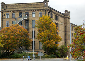 An autumn view of the impressive impressive facade 
 of the five-storey Victoria Mill in Shipley, the former textile mill now converted into luxury apartments