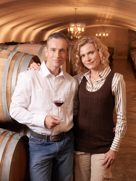 Couple Standing in Wine Cellar