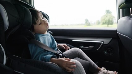 toddler girl sitting and sleeping in a car seat, safety baby chair travelling