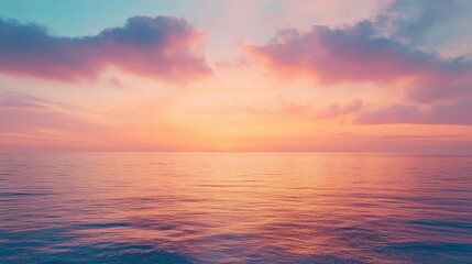 Fototapeta premium A tranquil sky at twilight with shades of orange and pink, the last light of day reflecting on a calm sea.