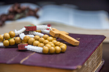 Holy Rosary on top of an old Bible. Christianity and Religious concept