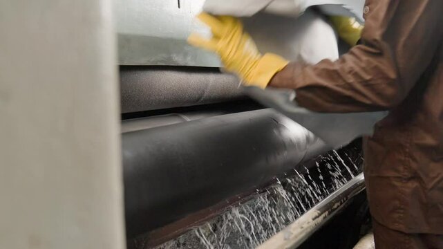 Worker Processing Animal Hide In A Industrial Coating Machine In A Leather Factory, Close Up Shot.