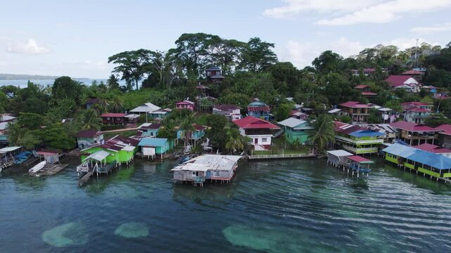 Aerial - Coastal houses on Bastimentos Island, Bocas del Toro, Panama, lush tropical scenery