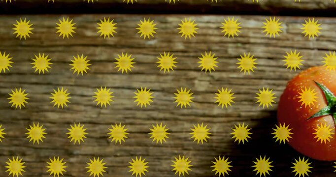 Yellow star shapes animation over wooden surface with tomato on right