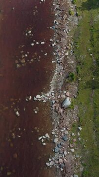 Vertical top down drone shot of sea water near coastline. Ecology. Pollution. Texture.