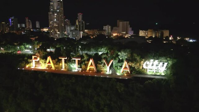 aerial Pattaya city sign illuminated at night