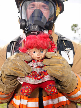 Portrait of Fire Fighter with Doll