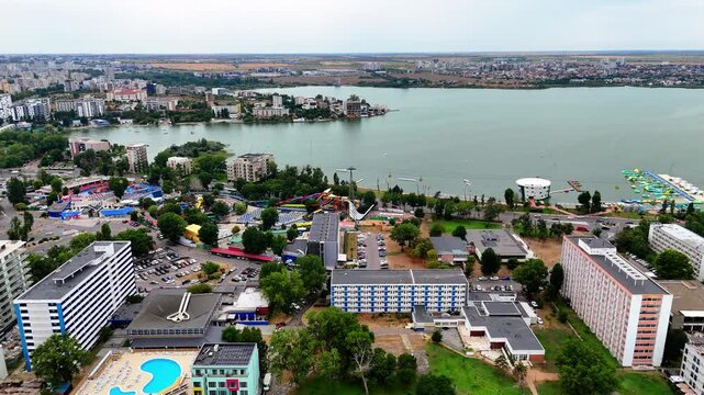 Aerial view flying towards Siutghiol lake and over Mamaia beach resort on a cloudy day