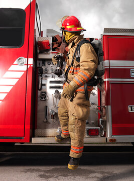 Fireman Pulling Fire Hose from Fire Truck