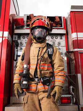 Fireman Pulling Fire Hose from Fire Truck
