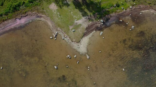 Coast erosion from a top down ascending drone shot at Baltic sea.