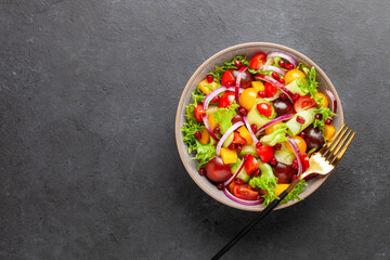 Easy vegetarian salad of fresh cucumber, tomato, sweet pepper,  onion  with pomegranate seeds. Healthy food.