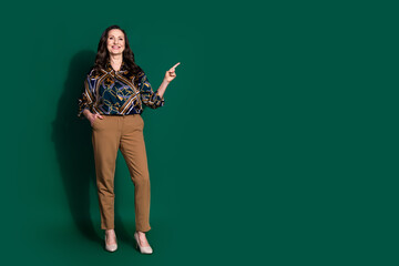 Photo of stunning retired lady wear stylish clothes recommend empty space isolated on dark green color background