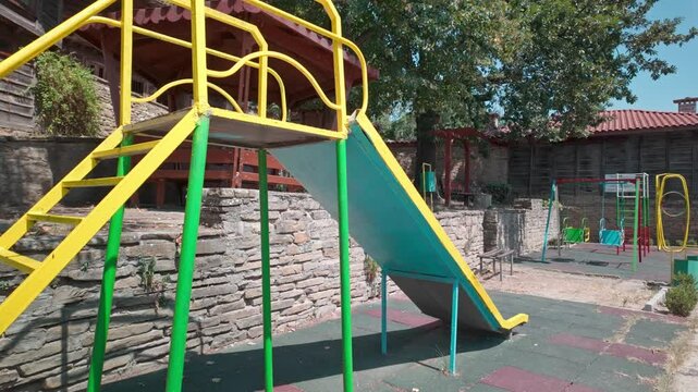 Bright colourful children's play area park in Balkan mountain village