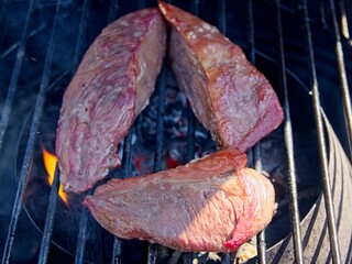 Picanha, or top sirloin cap, steaks on a charcoal grill