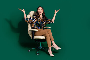 Photo of adorable gorgeous pretty lady dressed trendy clothes sitting office chair isolated on dark...