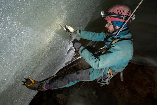 Researcher takes samples from an ice cave in European Alps of Austria