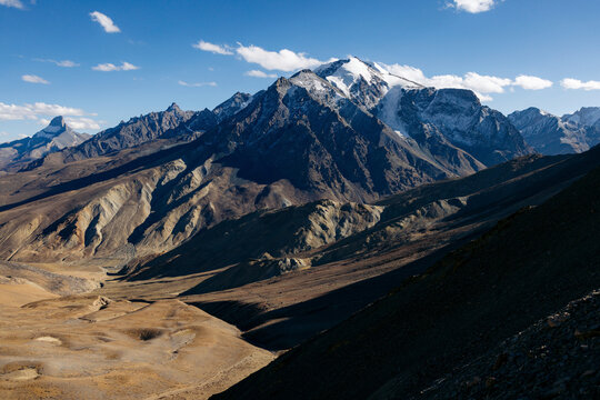 Beautiful rugged mountaintops in the Himalayas, and valley with road between Zangla and Wanla, Zanskar, Ladakh; Zanskar, Ladakh, India