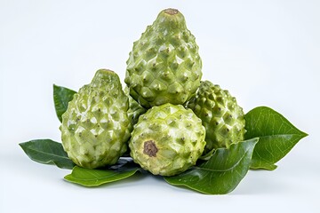 Obraz premium A cluster of green cherimoya fruits on leaves, showcasing their textured skin.
