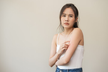 Dermatology, asian young woman reaction from atopic, insect bites on her arm, hand in scratching...