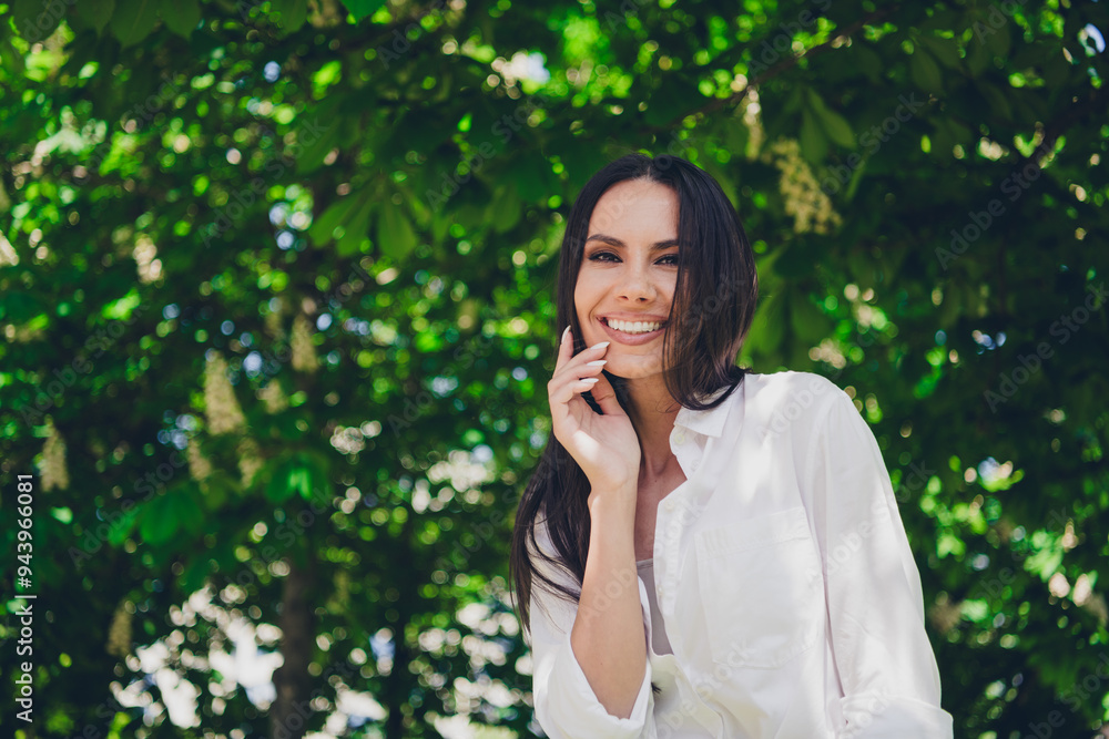 Wall mural Photo of young cheerful woman charming smile dreamy wear white outfit walk park sunny summer weather outside