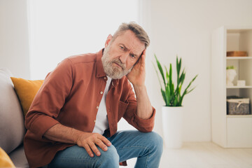 Photo of nice pensioner man sit couch depressed suffer grief dressed brown garment spend pastime...