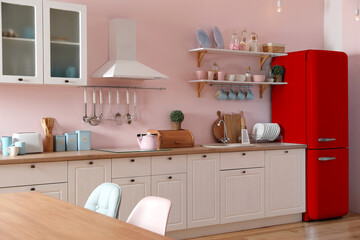 Red refrigerator in kitchen. Bright color accent in interior