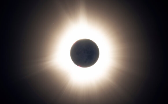Totality of a solar eclipse with the suns corona seen. A few solar prominences also exist; Fredricton, New Brunswick, Canada