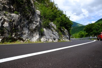 Picturesque view of rocky cliff and asphalt road in mountains