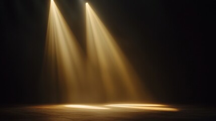 Two beams of golden light illuminate a dark stage, creating a dramatic atmosphere suitable for performances or events.