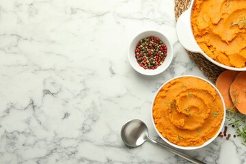 Delicious mashed sweet potatoes, spoon, microgreens, spices and vegetables on white marble table, top view. Space for text
