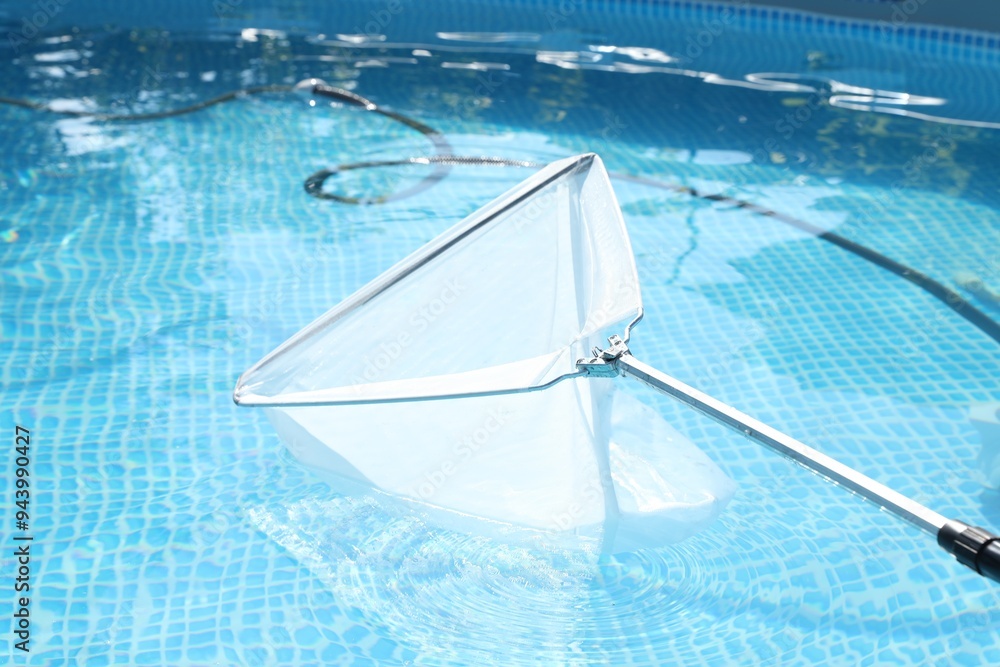 Canvas Prints Cleaning swimming pool with skimmer net, closeup