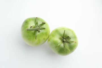 Fresh unripe tomatoes isolated on white, top view