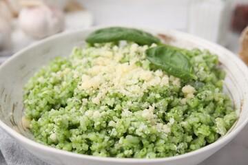 Tasty spinach risotto served on table, closeup