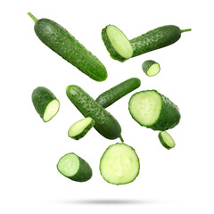 Many ripe cucumbers falling on white background