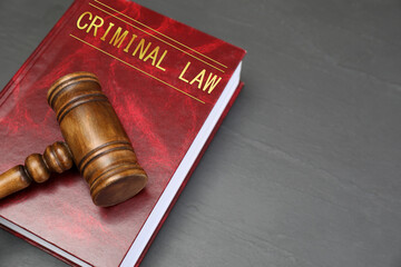 Book Criminal Law and judge's gavel on grey table
