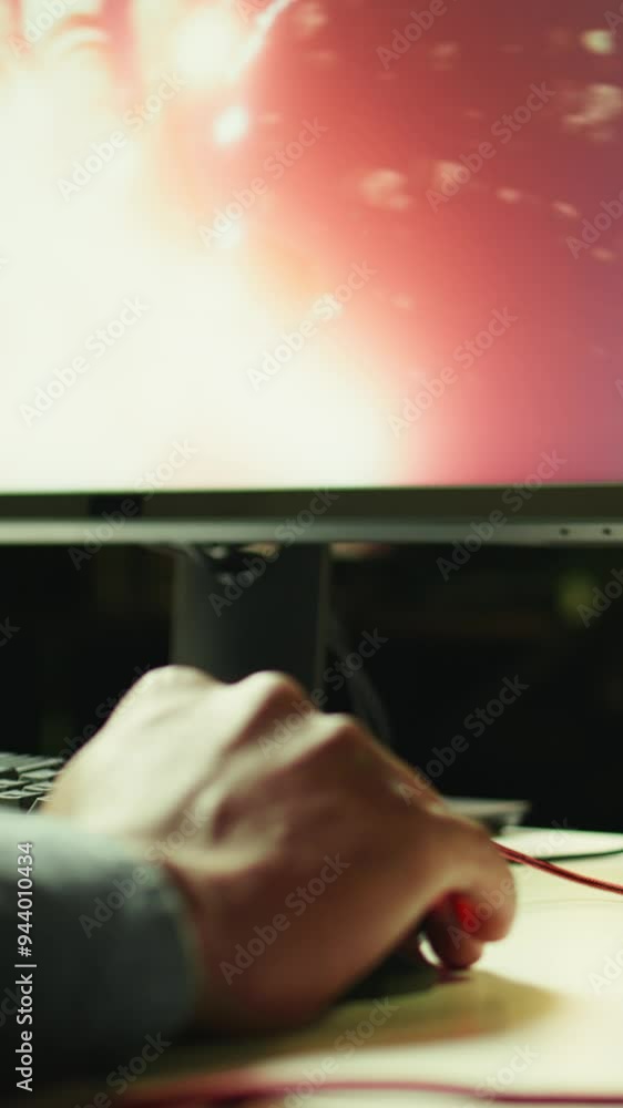 Aufkleber vertical video gamer using keyboard and wired mouse to play videogames on desktop pc, close up shot.
