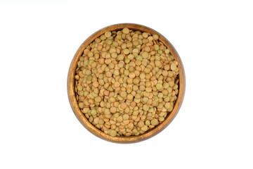 Green lentils in wooden bowl on isolated white background. Top view, copy space. Flat lay.