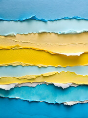 Fototapeta premium Torn Paper Tapestry: A vibrant collage of blue, yellow, and white torn paper strips, forming a textured abstract background with copy space. 