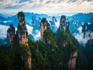A view of a mountain range covered in clouds and trees