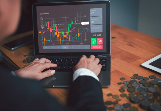 Businessman sitting and analyzing stock candlestick charts  ups and downs of the stock exchange market Concept of investing in the stock market Earning profits from investing on the digital financial