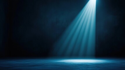 A single spotlight illuminates a dark stage with blue light.