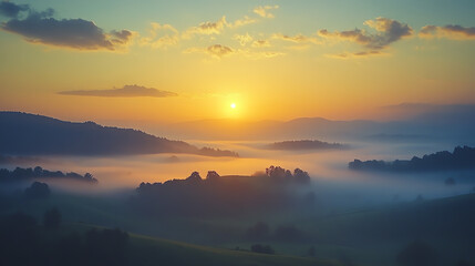 Obraz premium Sunrise breaking through morning fog over rolling hills, foggy weather, peaceful dawn