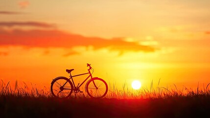 Obraz premium A serene sunset silhouette of a bicycle against a vibrant sky, capturing the essence of freedom and outdoor adventure.